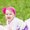 Baby with pink bow on the grass - Swedish girl names